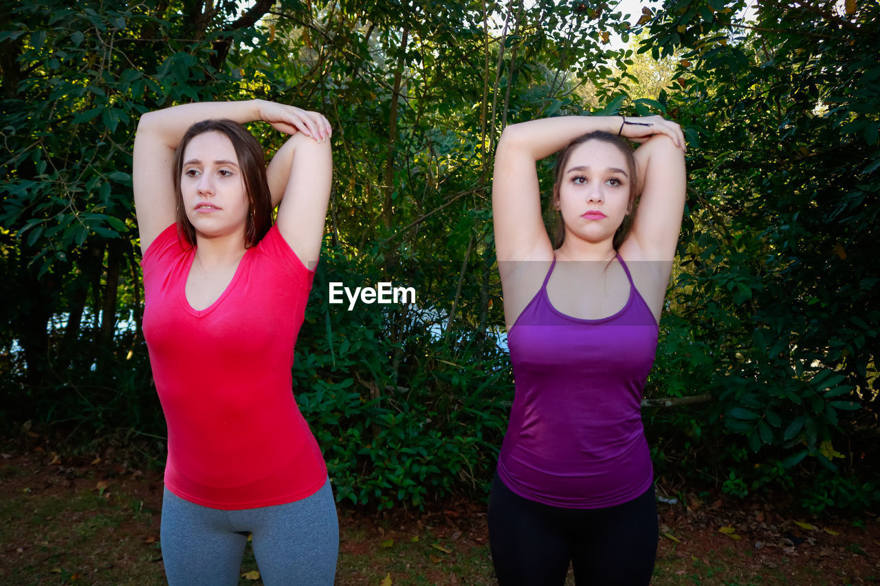 PORTRAIT OF BEAUTIFUL WOMAN AGAINST TREES