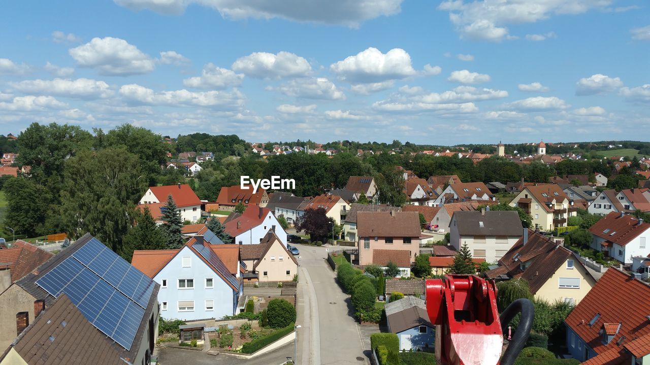 HIGH ANGLE VIEW OF HOUSES AGAINST BUILDINGS IN TOWN