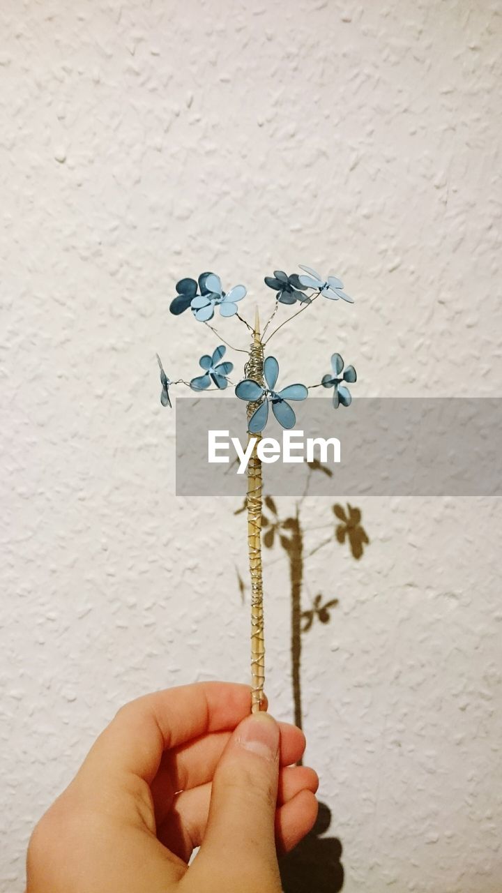 Close-up of hand holding crafted flower