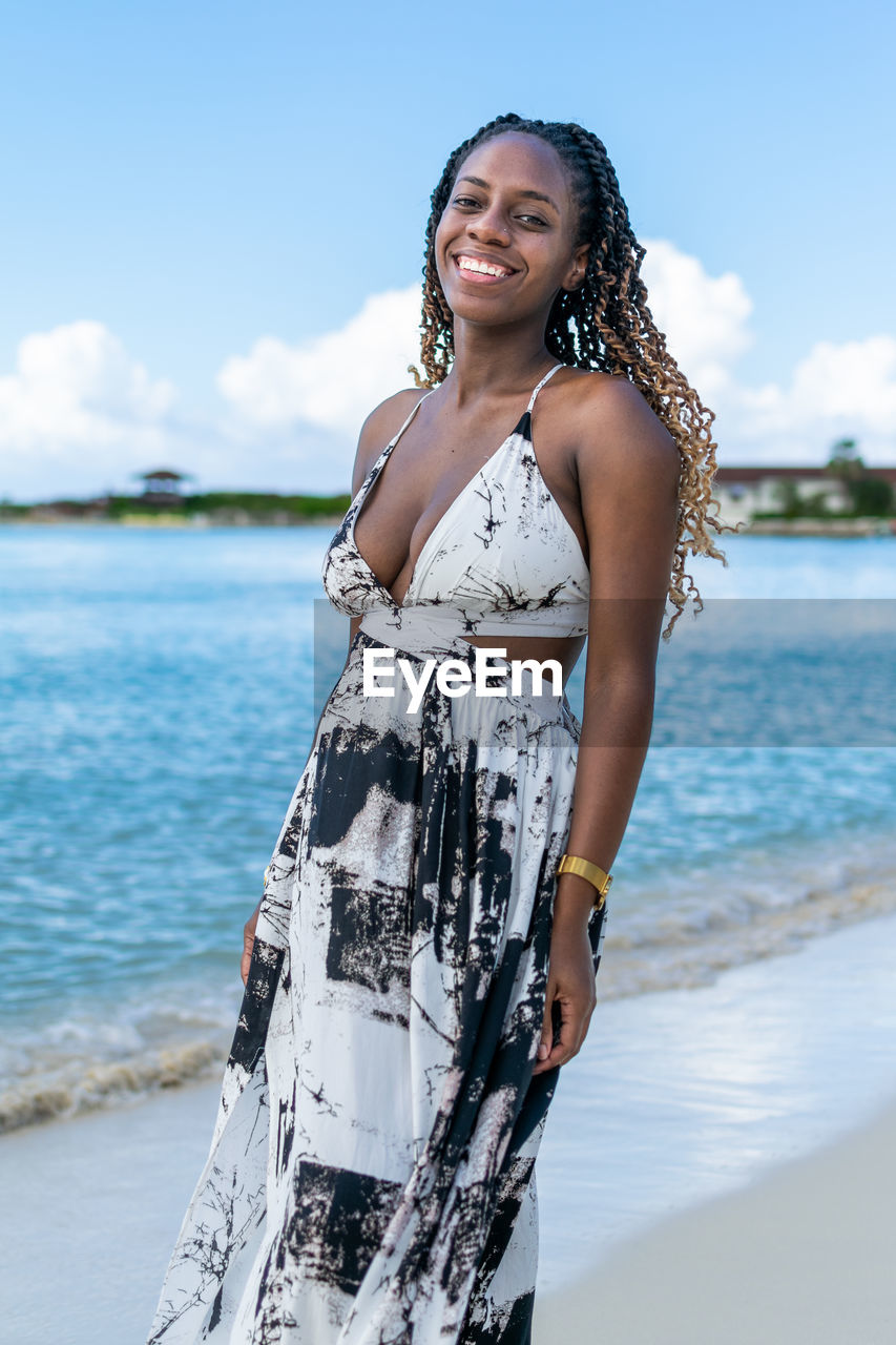 Portrait of an attractive young woman standing at the beach