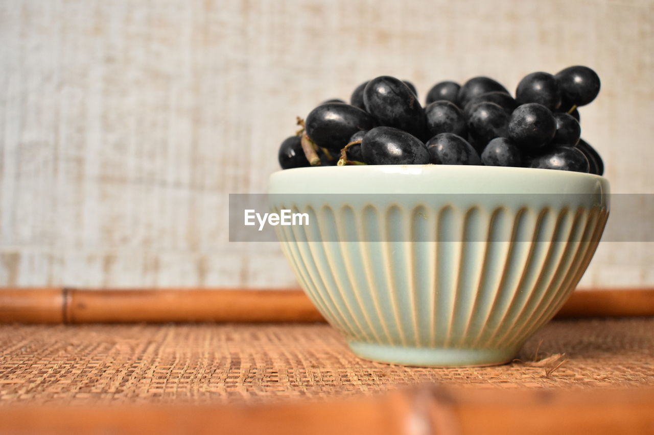 CLOSE-UP OF FRUITS ON TABLE