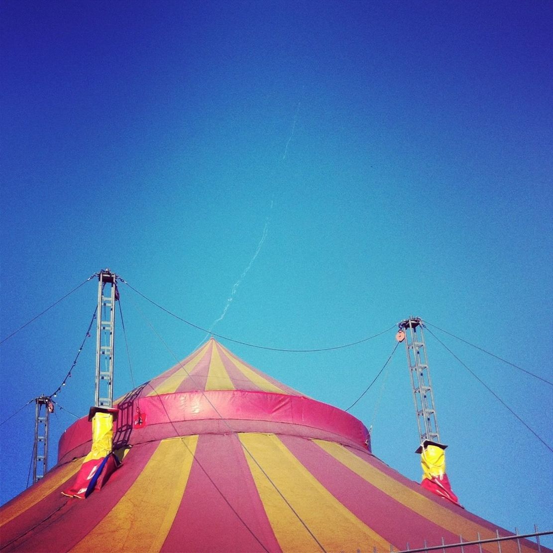 High section of tent against clear blue sky