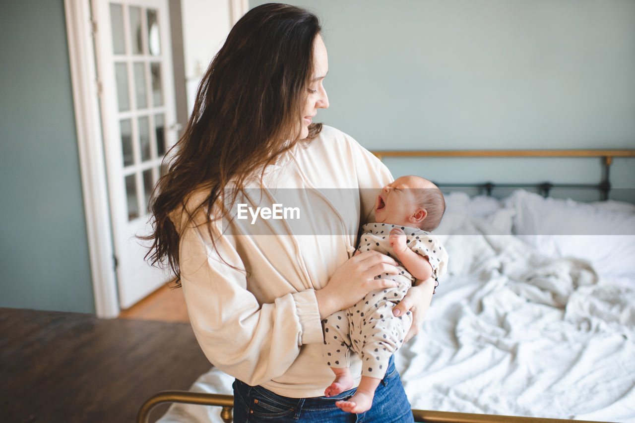 Smiling mother with daughter at home