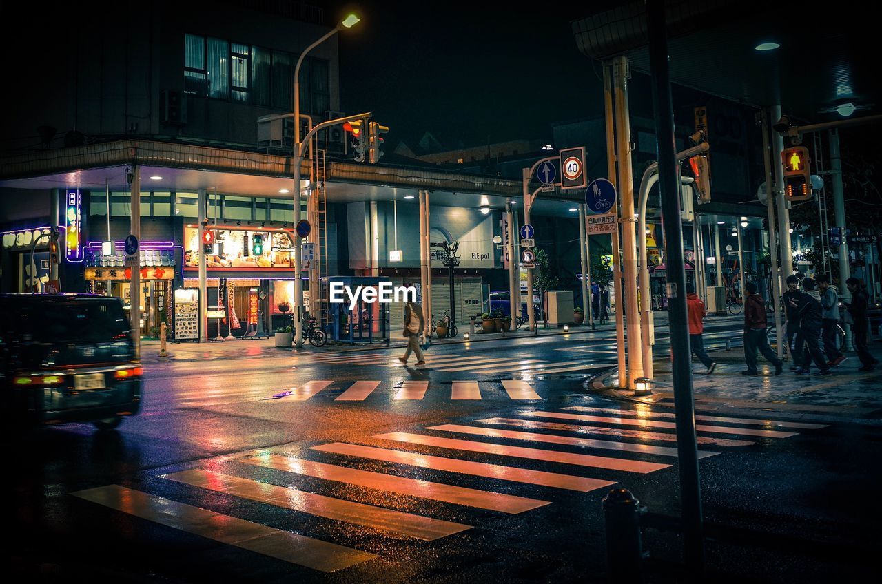 Illuminated city street at night