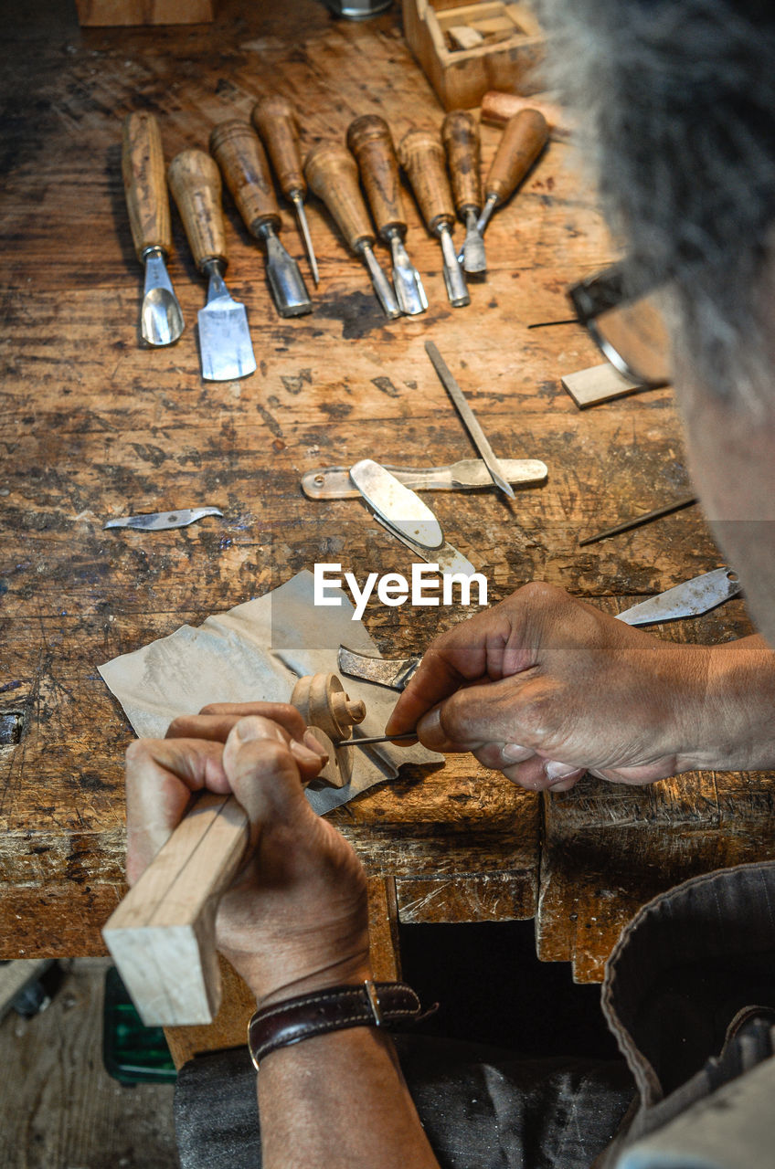 Violin maker luthier hand working a new violin scroll