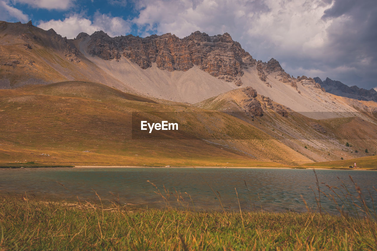 Scenic view of lake and mountains against sky