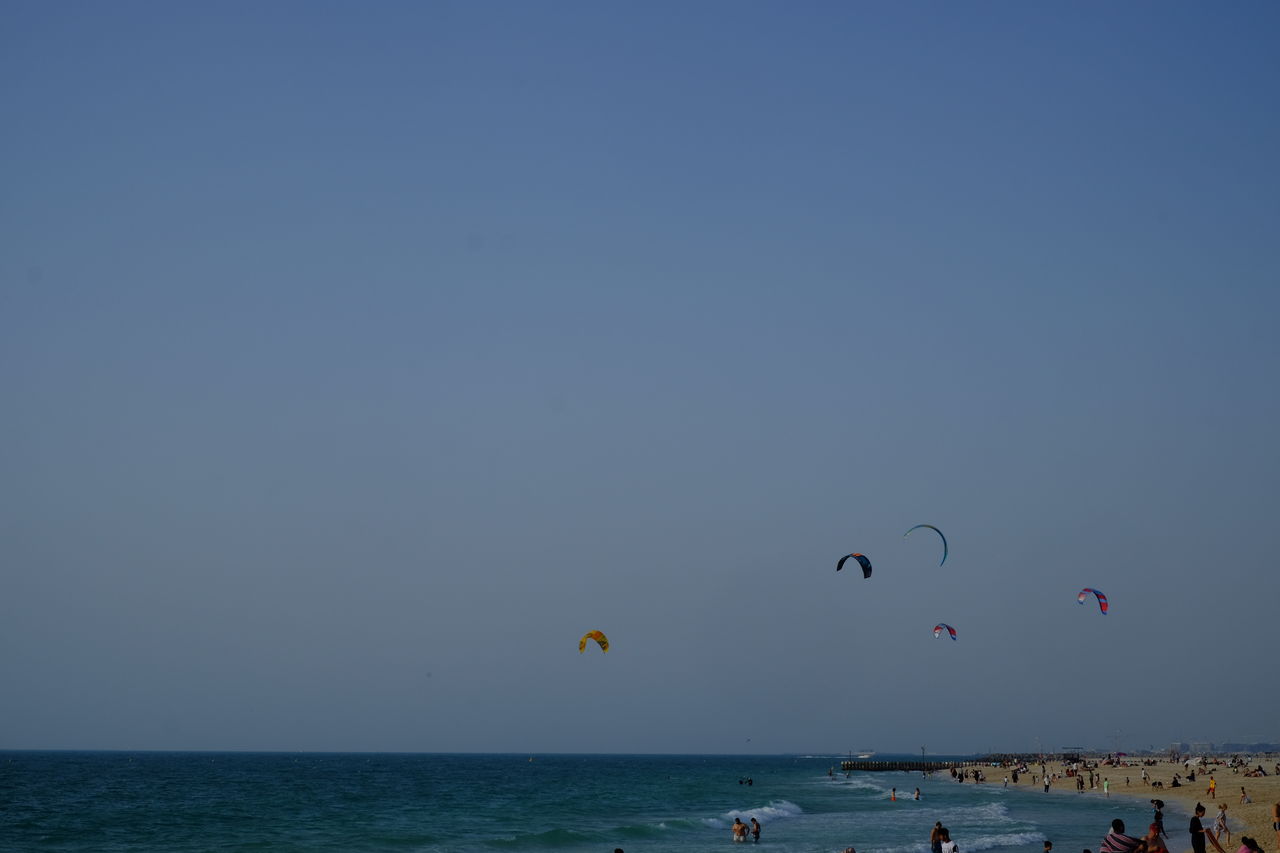 Scenic view of kites against sky