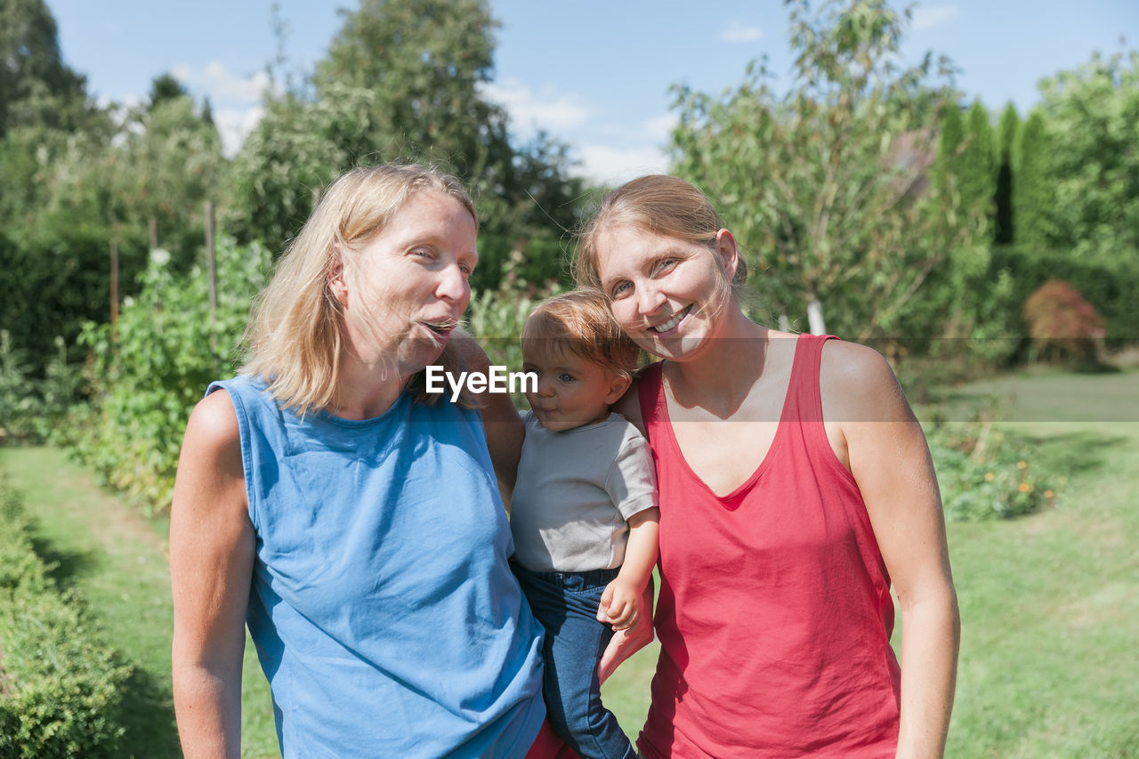 Portrait of happy mother and daughter at park