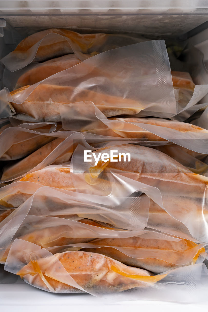 HIGH ANGLE VIEW OF DEAD FISH IN PLASTIC