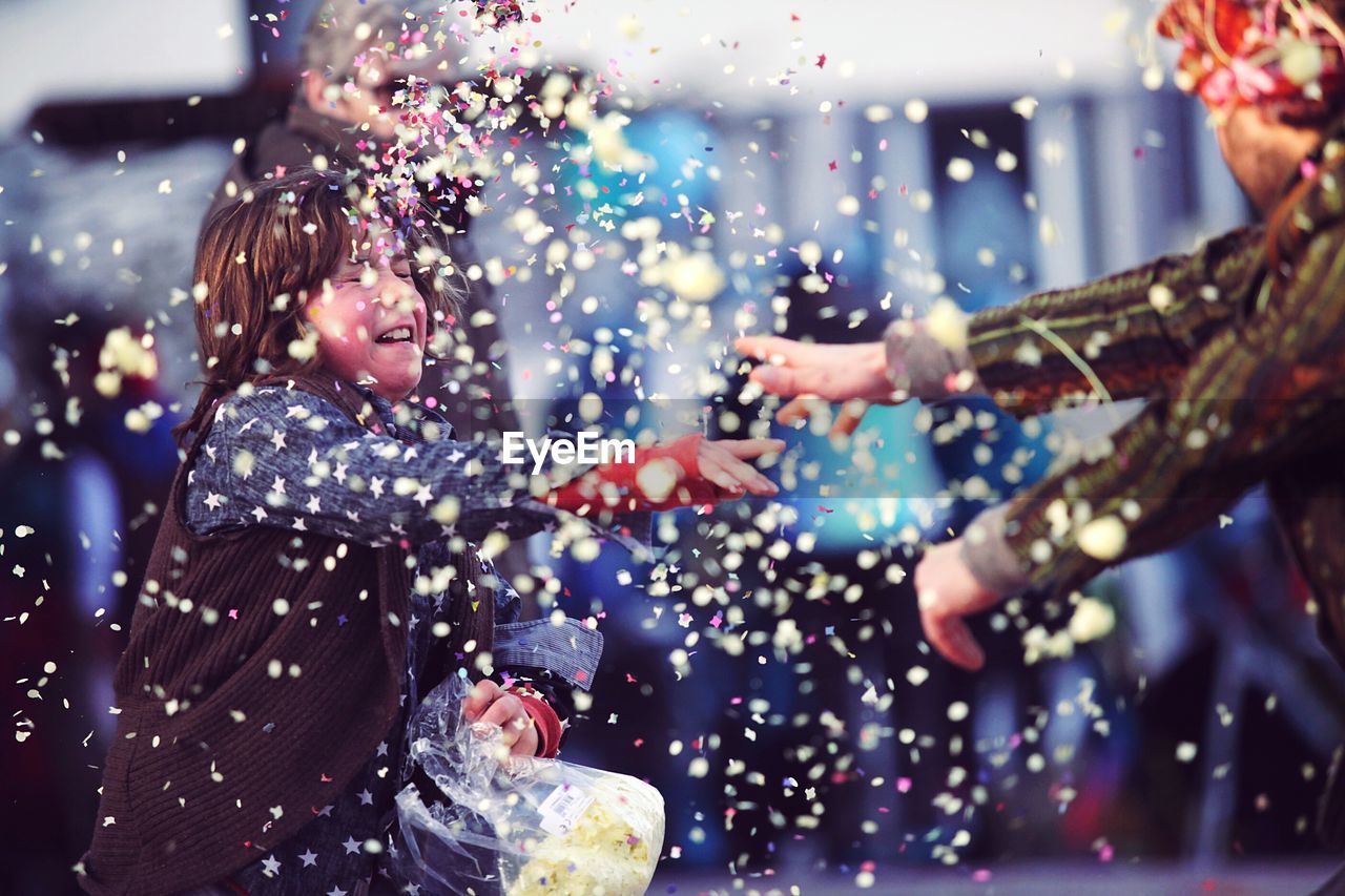 Father and daughter throwing confetti on each other