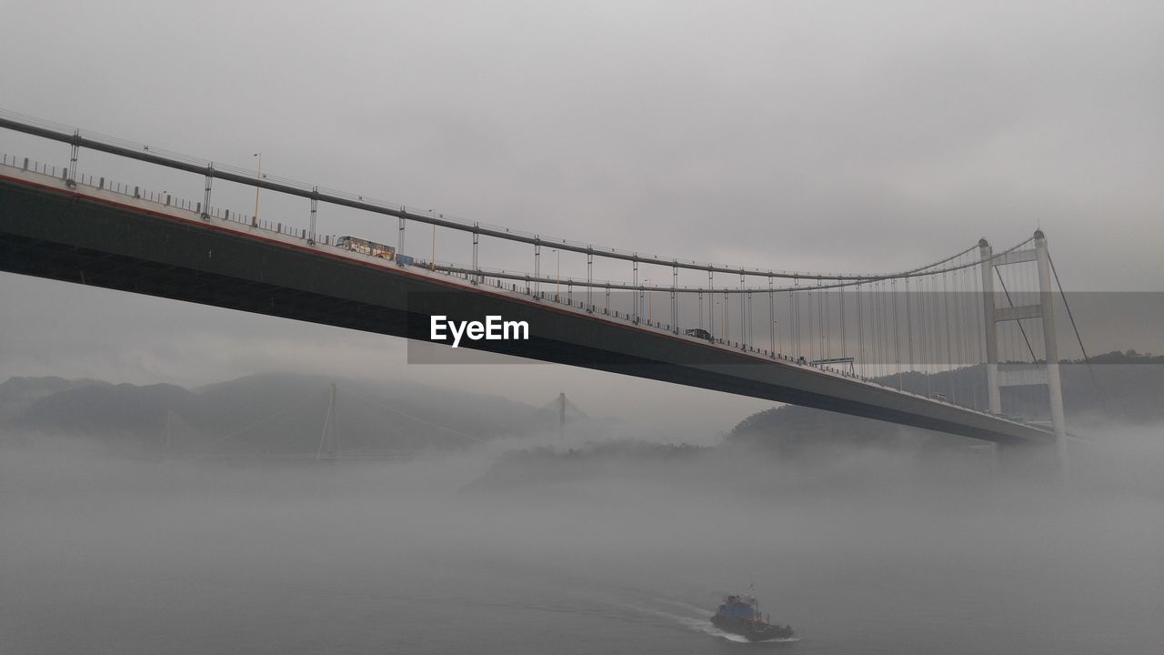 Low angle view of bridge on a foggy day