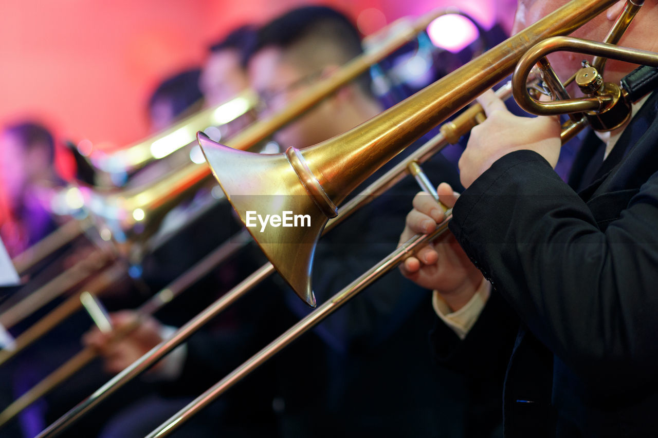 Men playing trombone at event