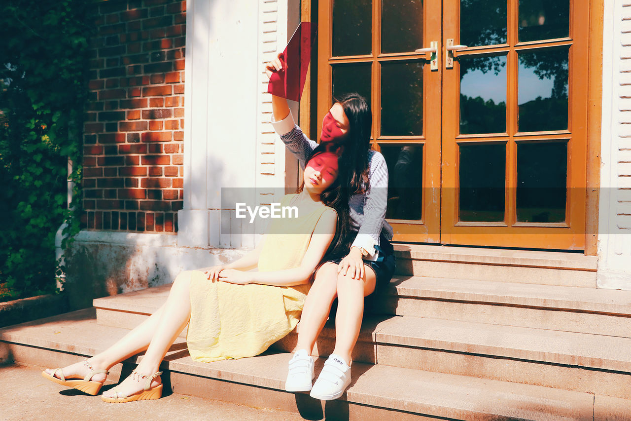 YOUNG COUPLE SITTING ON SEAT