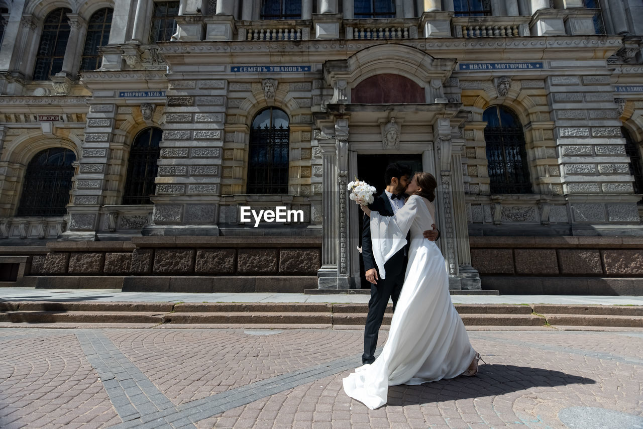 Portrait of woman standing outside historic building