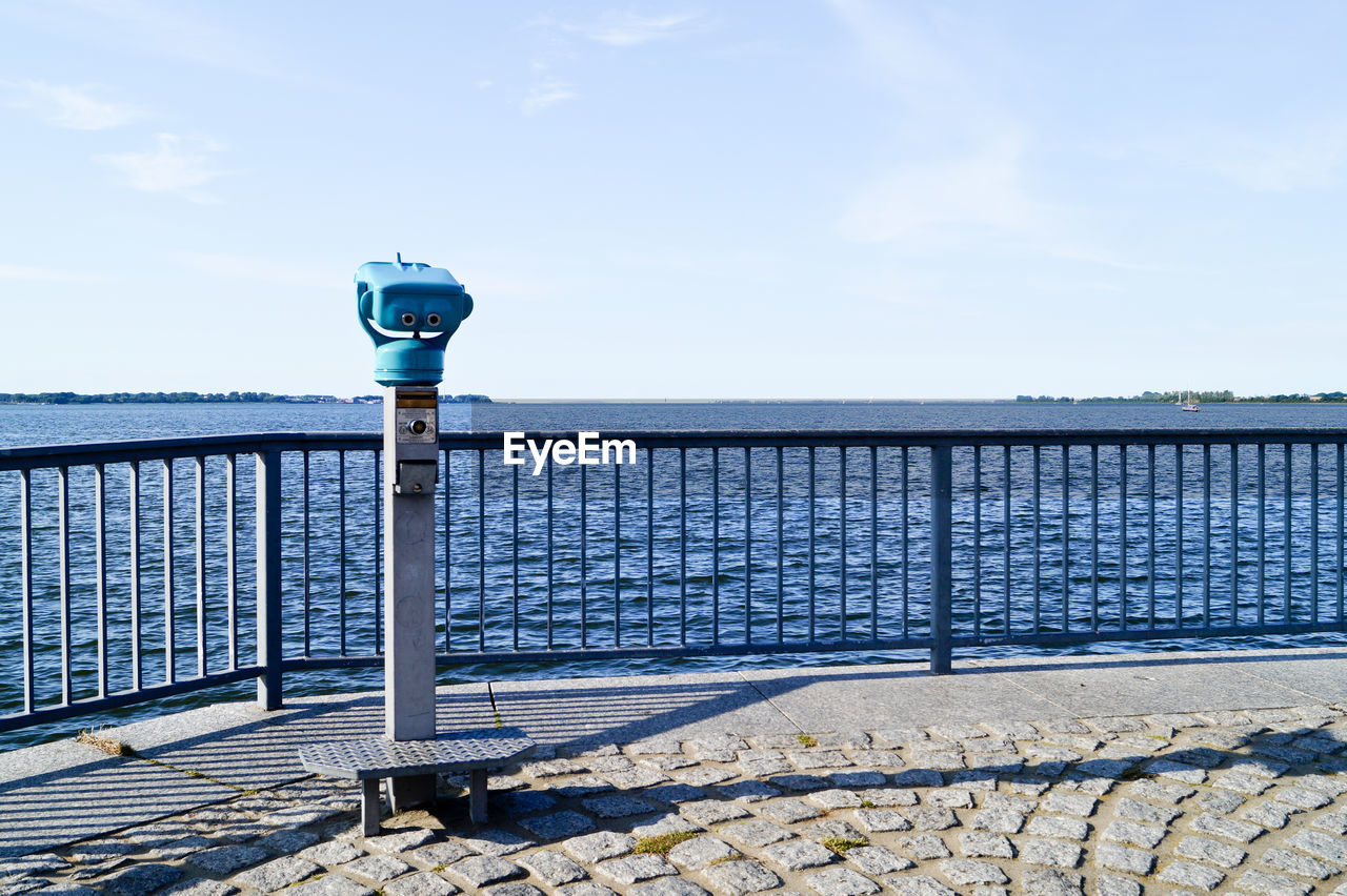 Coin-operated binoculars by sea against sky at stralsund