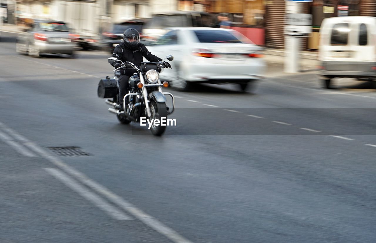 VEHICLES ON STREET IN CITY