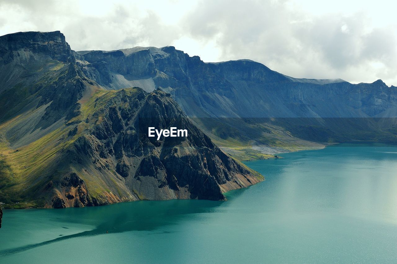 Scenic view of lake and mountains against sky