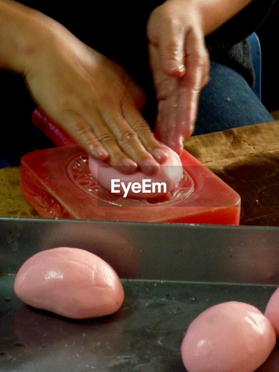 Midsection of person making rice cake