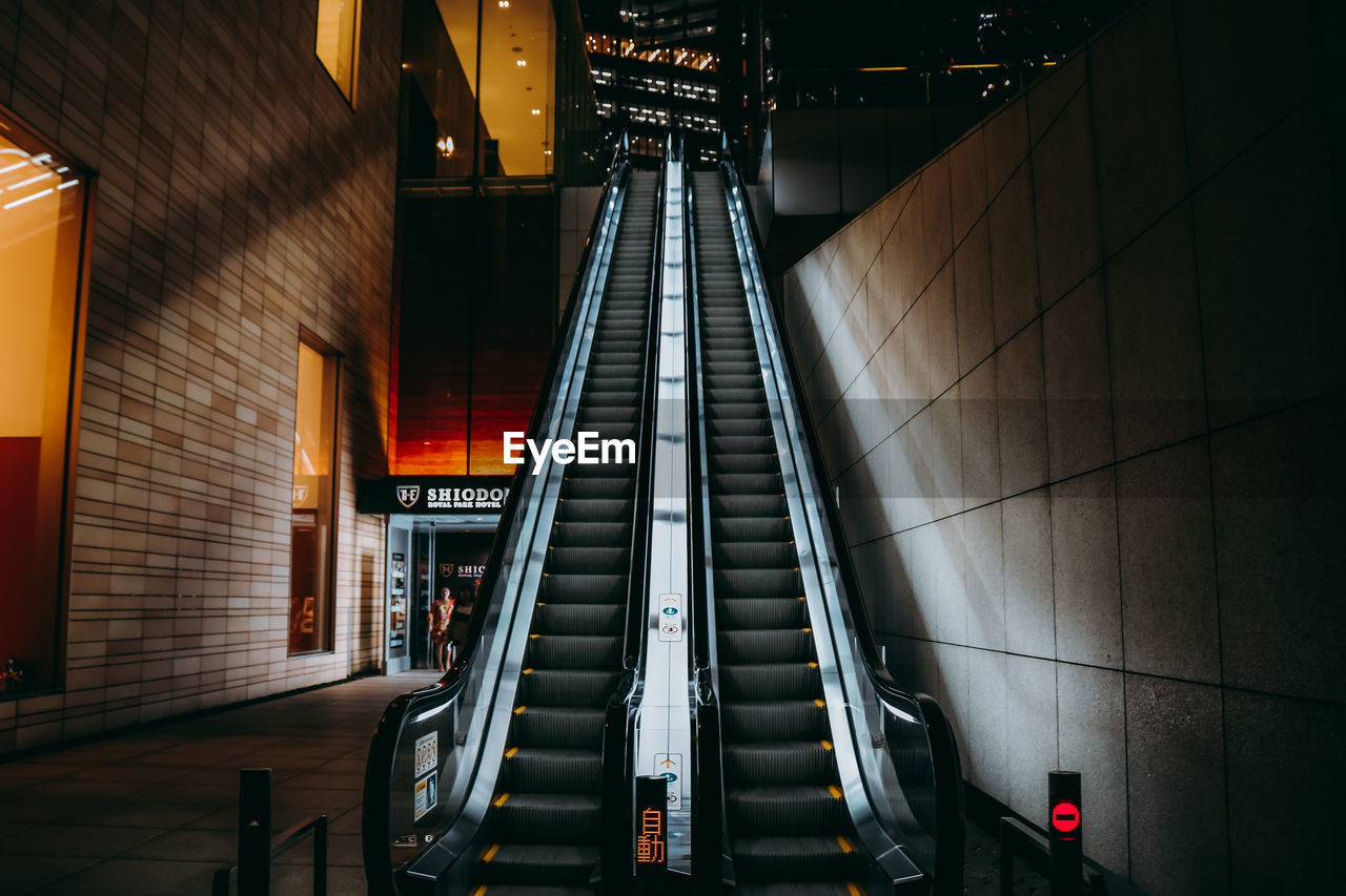 LOW ANGLE VIEW OF ESCALATOR IN SUBWAY