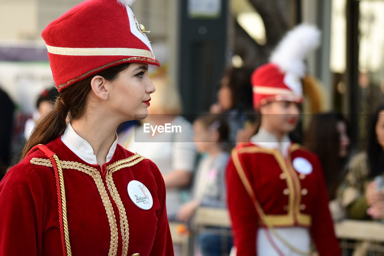 PORTRAIT OF WOMAN WEARING RED HAT