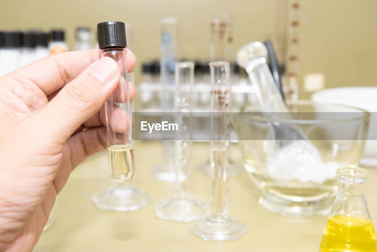 Cropped hands of scientist holding liquid in test tube at laboratory