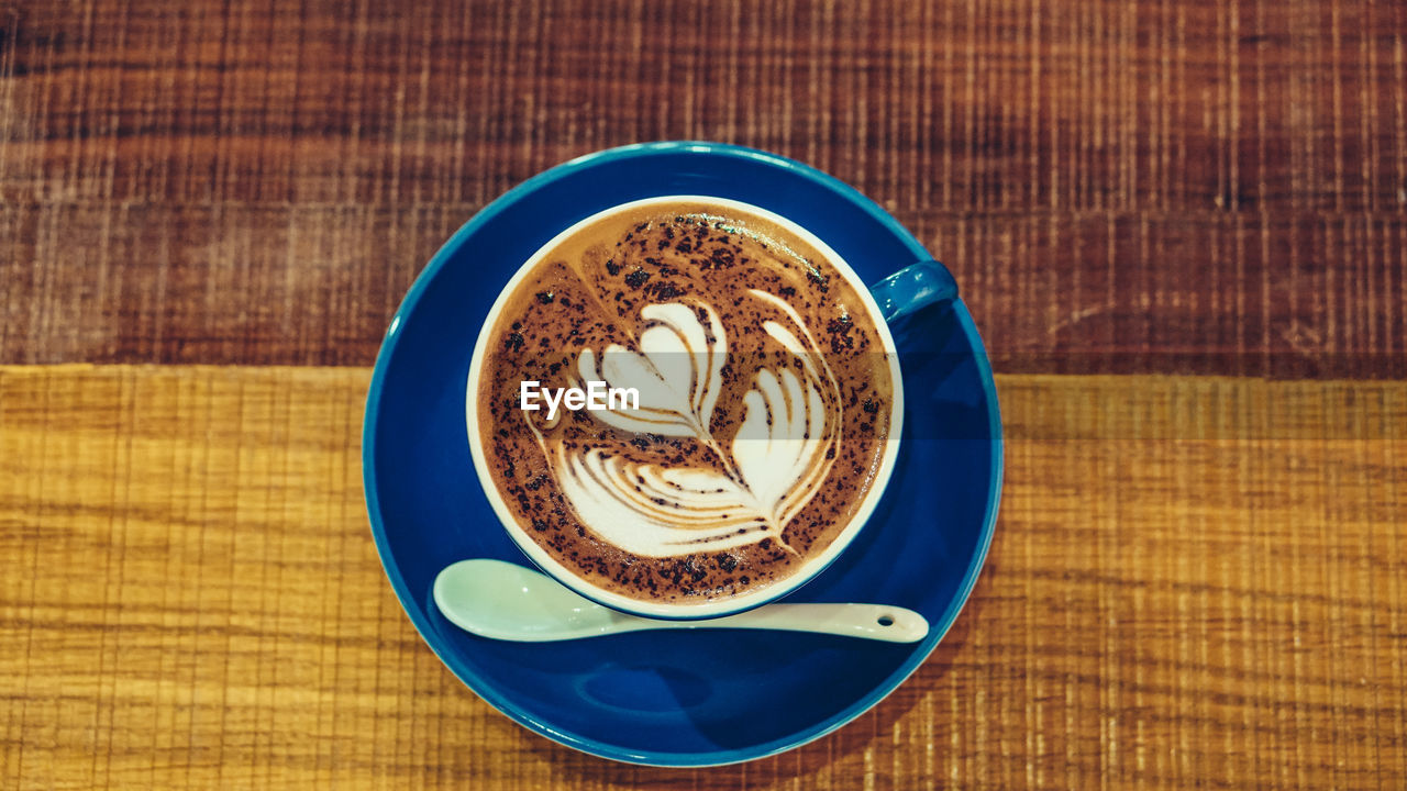 food and drink, table, coffee cup, drink, coffee, saucer, mug, cup, refreshment, crockery, still life, wood, indoors, latte, no people, tableware, froth art, food, hot drink, frothy drink, cappuccino, plate, directly above, freshness, pattern, close-up, high angle view, coffee milk