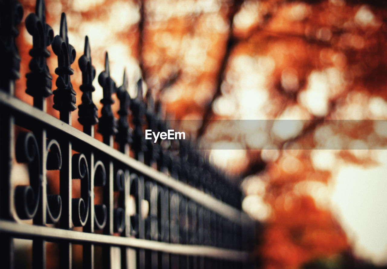 Low angle view of metal railing against defocused background