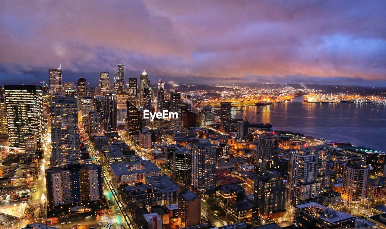 High angle view of illuminated buildings against sky at dusk