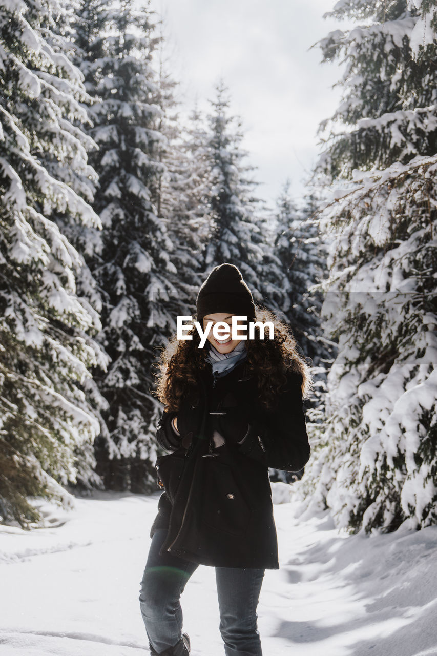 Full length of woman standing on snow covered land