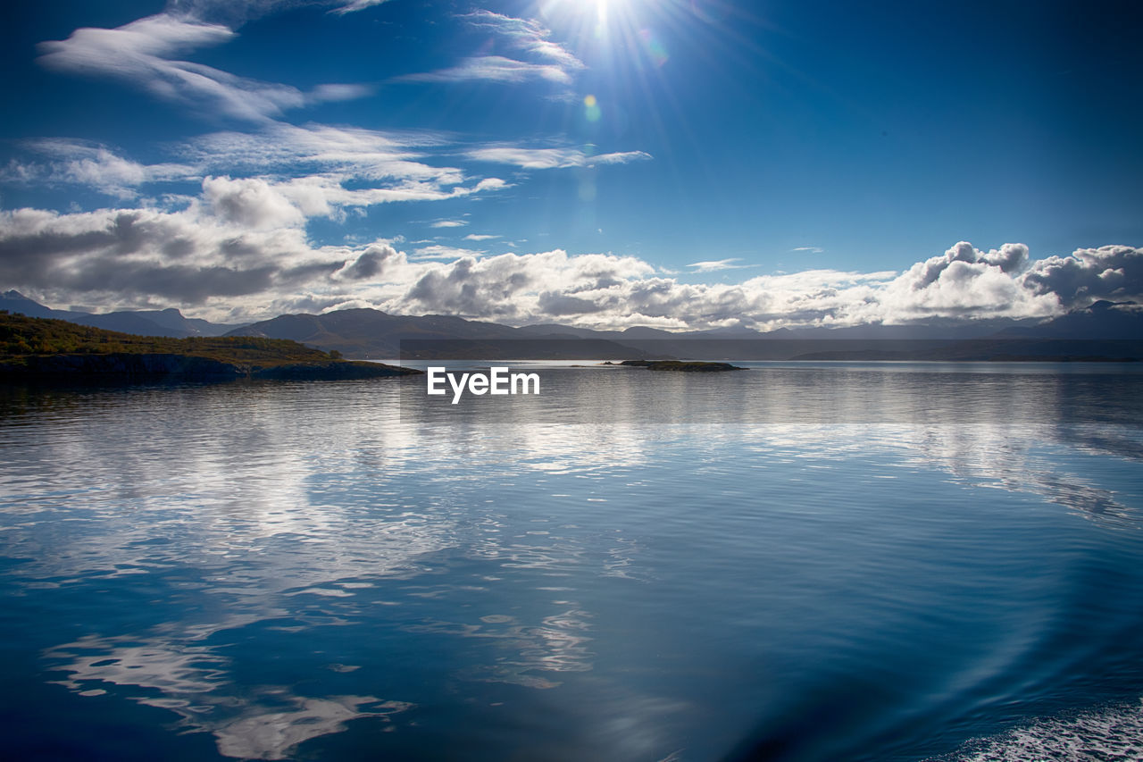 reflection, water, sky, cloud, scenics - nature, horizon, mountain, beauty in nature, nature, environment, sunlight, blue, landscape, snow, cold temperature, sea, tranquility, tranquil scene, no people, winter, ocean, mountain range, dusk, travel destinations, outdoors, travel, sun, sunbeam, land, ice, day, morning, wave, moonlight, idyllic