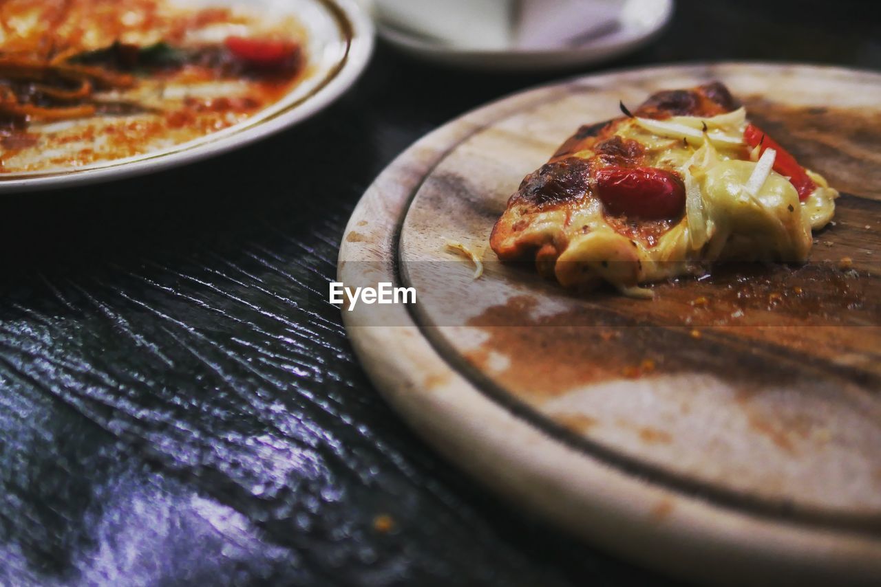 Close-up of pizza on serving board at table