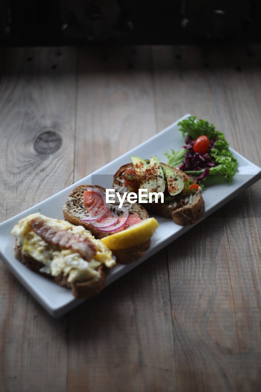 HIGH ANGLE VIEW OF SERVING FOOD ON TABLE