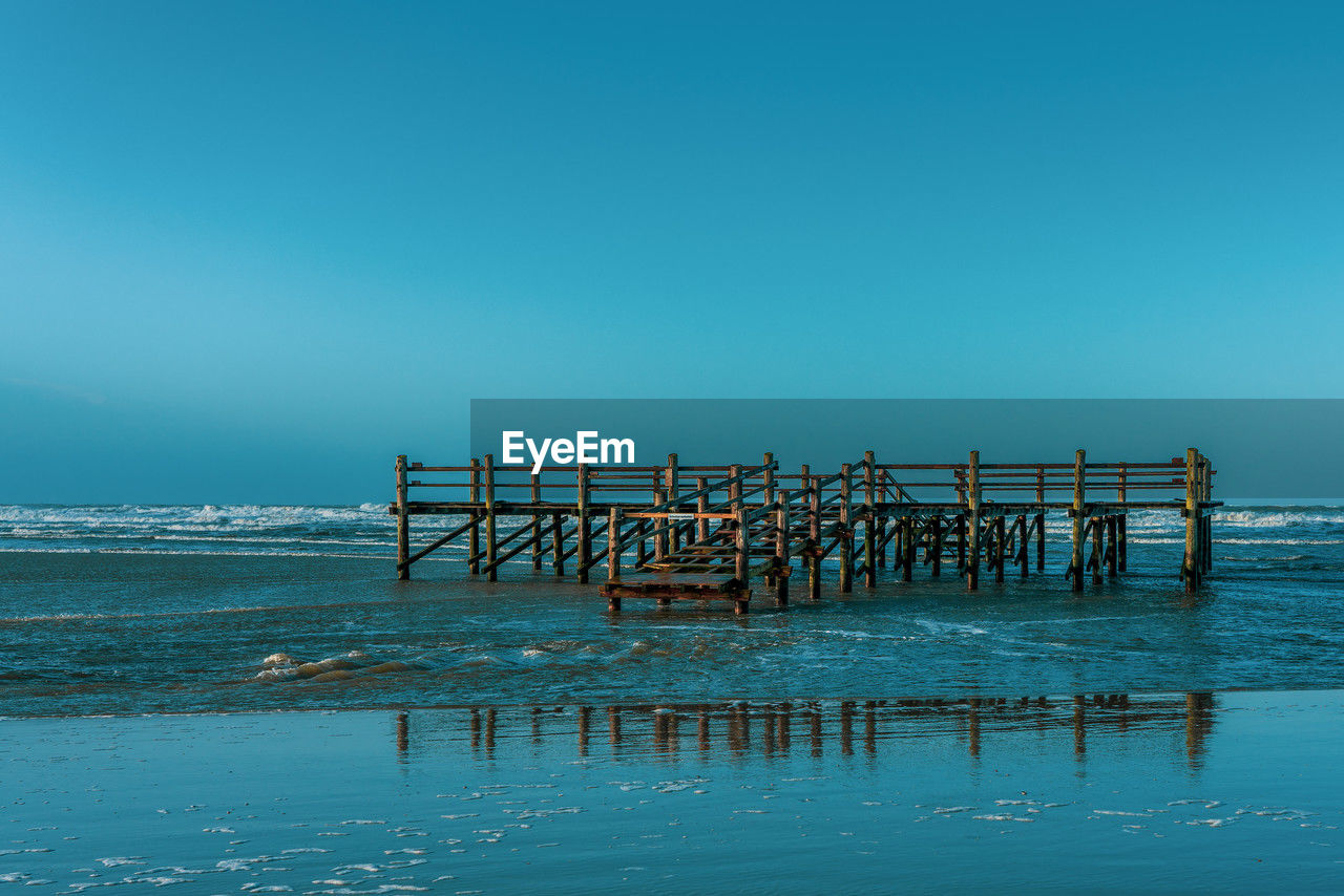 Pile dwelling on the norsee beach of sankt peter-ording in germany