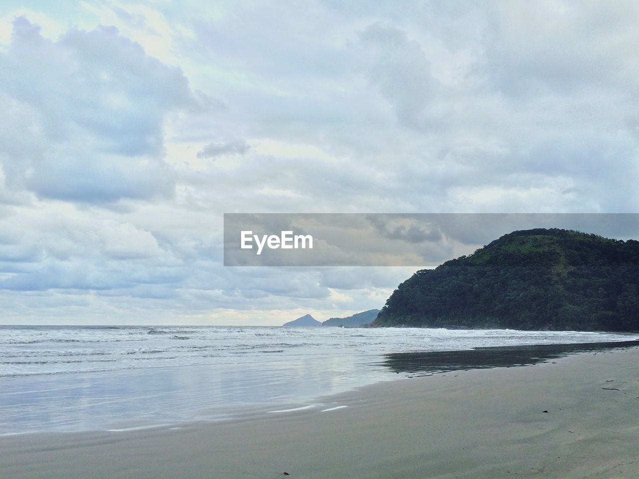 Scenic view of sea against cloudy sky