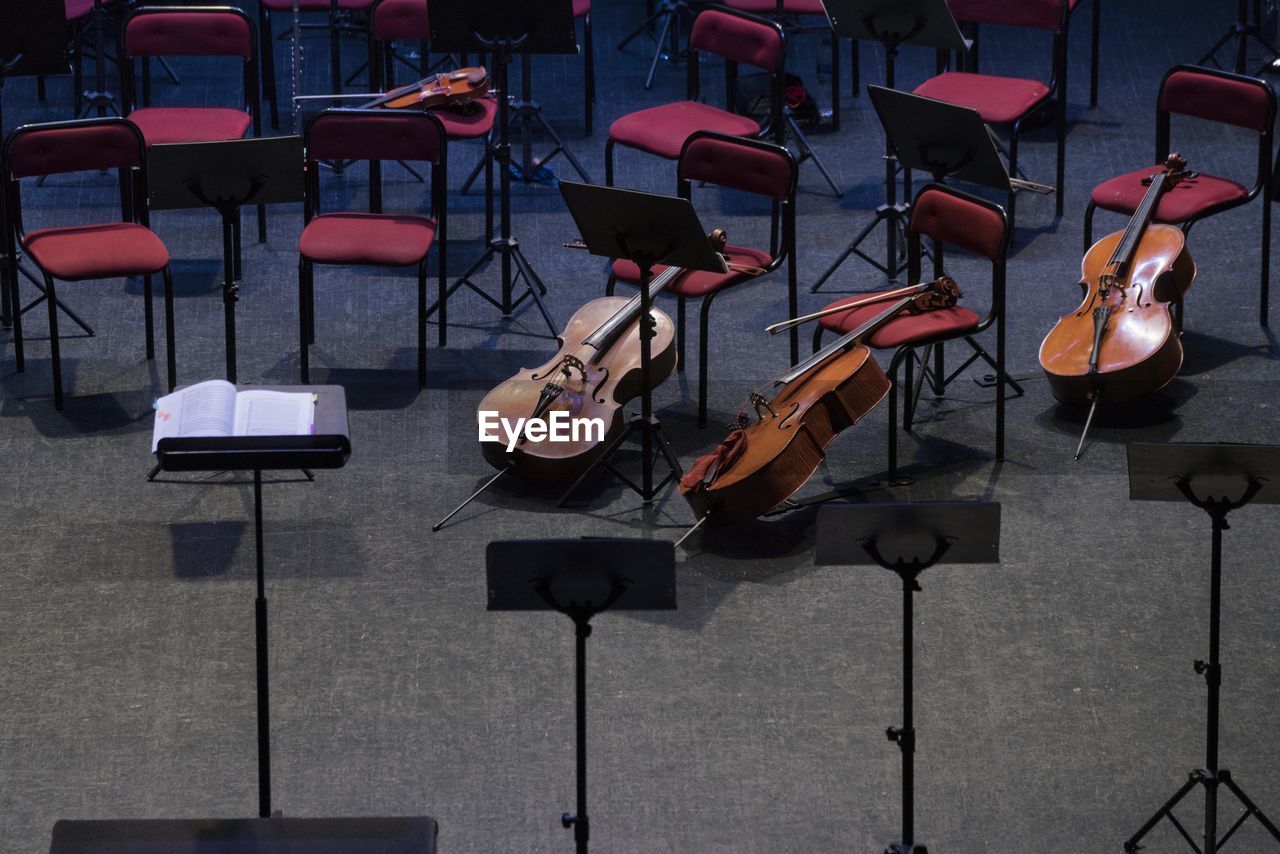 High angle view of violins and chairs in concert hall