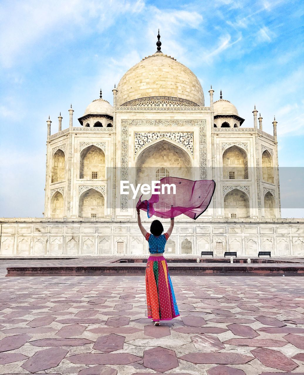 Rear view of woman holding dupatta against taj mahal