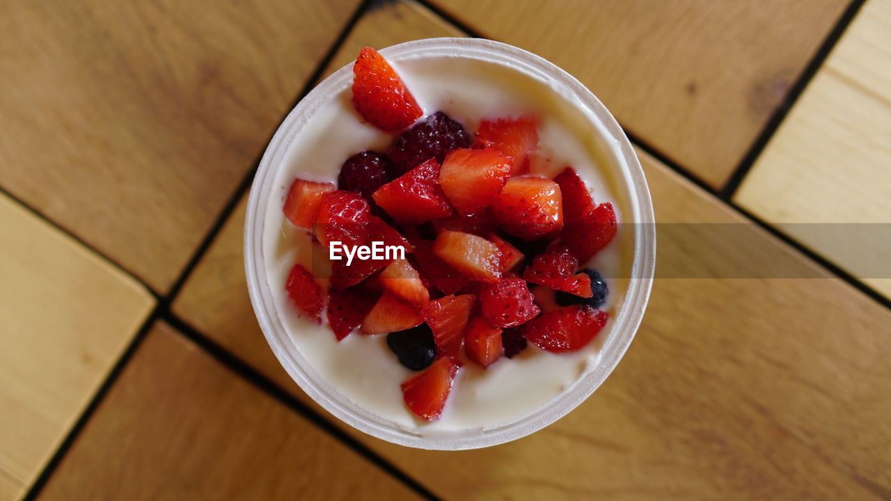 food and drink, food, healthy eating, fruit, berry, strawberry, plant, freshness, wellbeing, bowl, wood, meal, dish, table, produce, high angle view, red, indoors, dessert, no people, breakfast, directly above, sweet food, still life, close-up, raspberry