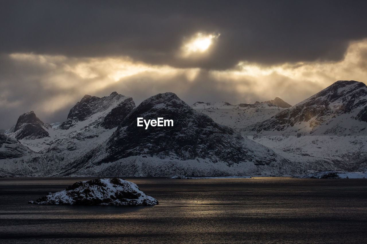 Scenic view of snowcapped mountains against sky during sunset