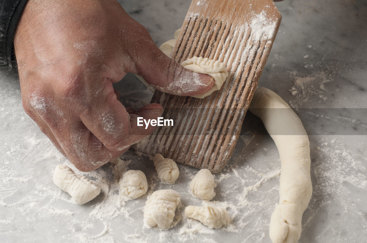 Cropped hands of chef preparing food on table in commercial kitchen