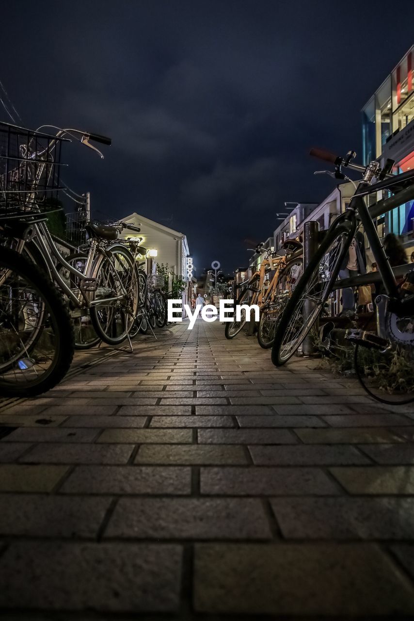 BICYCLE PARKED ON STREET AT NIGHT