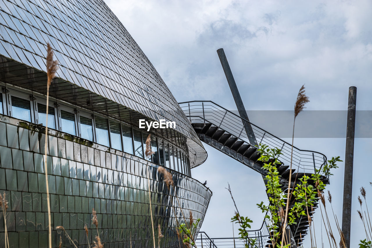 urban area, architecture, sky, cloud, built structure, sport venue, nature, stadium, building exterior, business, city, industry, transport, outdoors, business finance and industry, building, skyscraper, low angle view, no people, finance, day, facade, travel