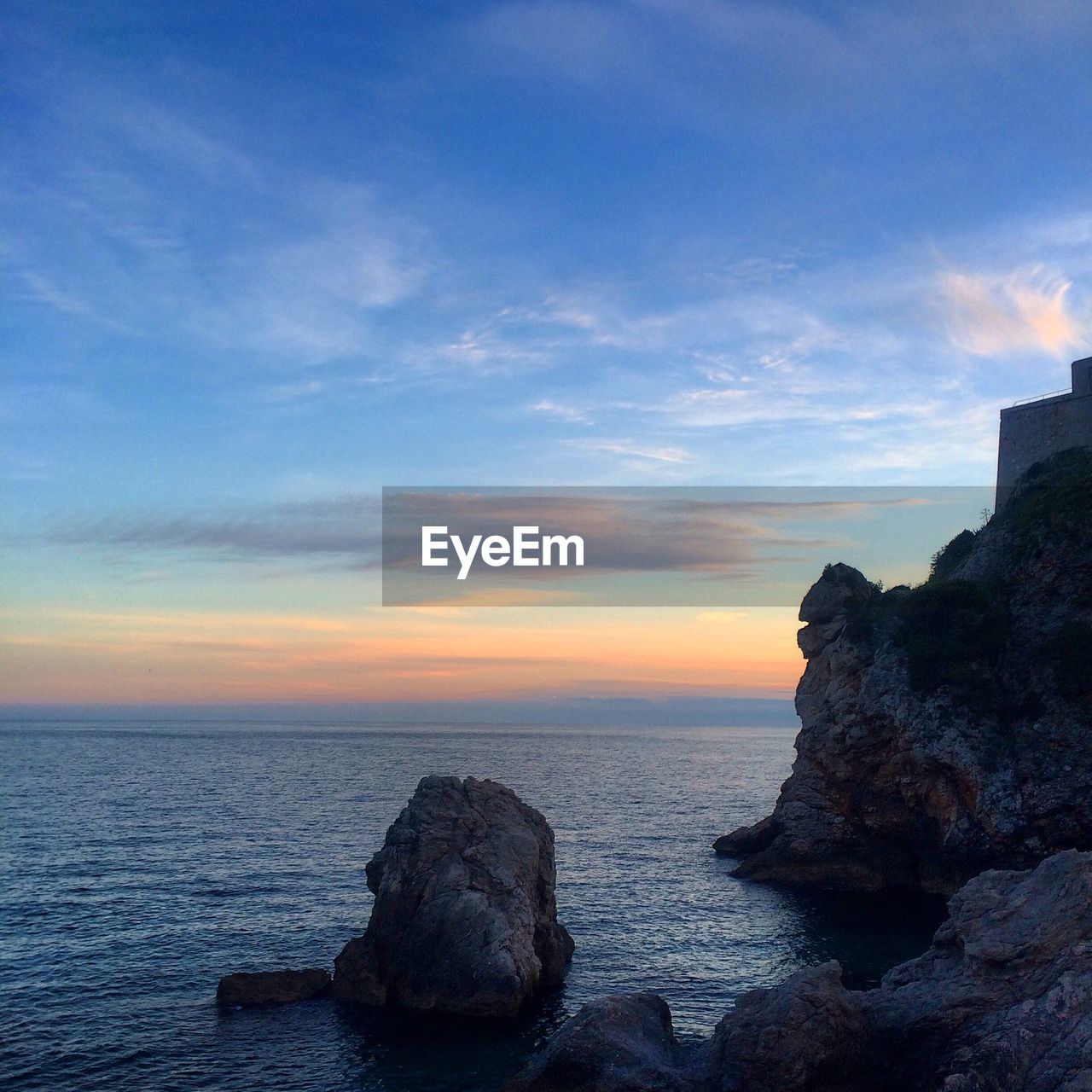 Scenic view of sea against sky at sunset