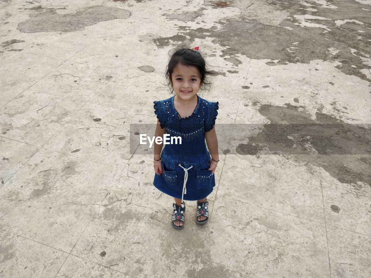 HIGH ANGLE PORTRAIT OF SMILING GIRL IN CLOTHING