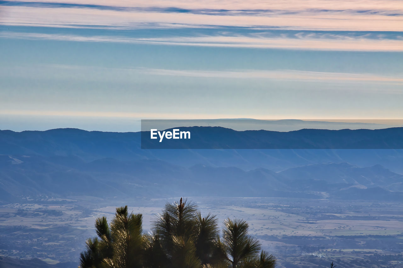 SCENIC VIEW OF TREE MOUNTAINS AGAINST SKY