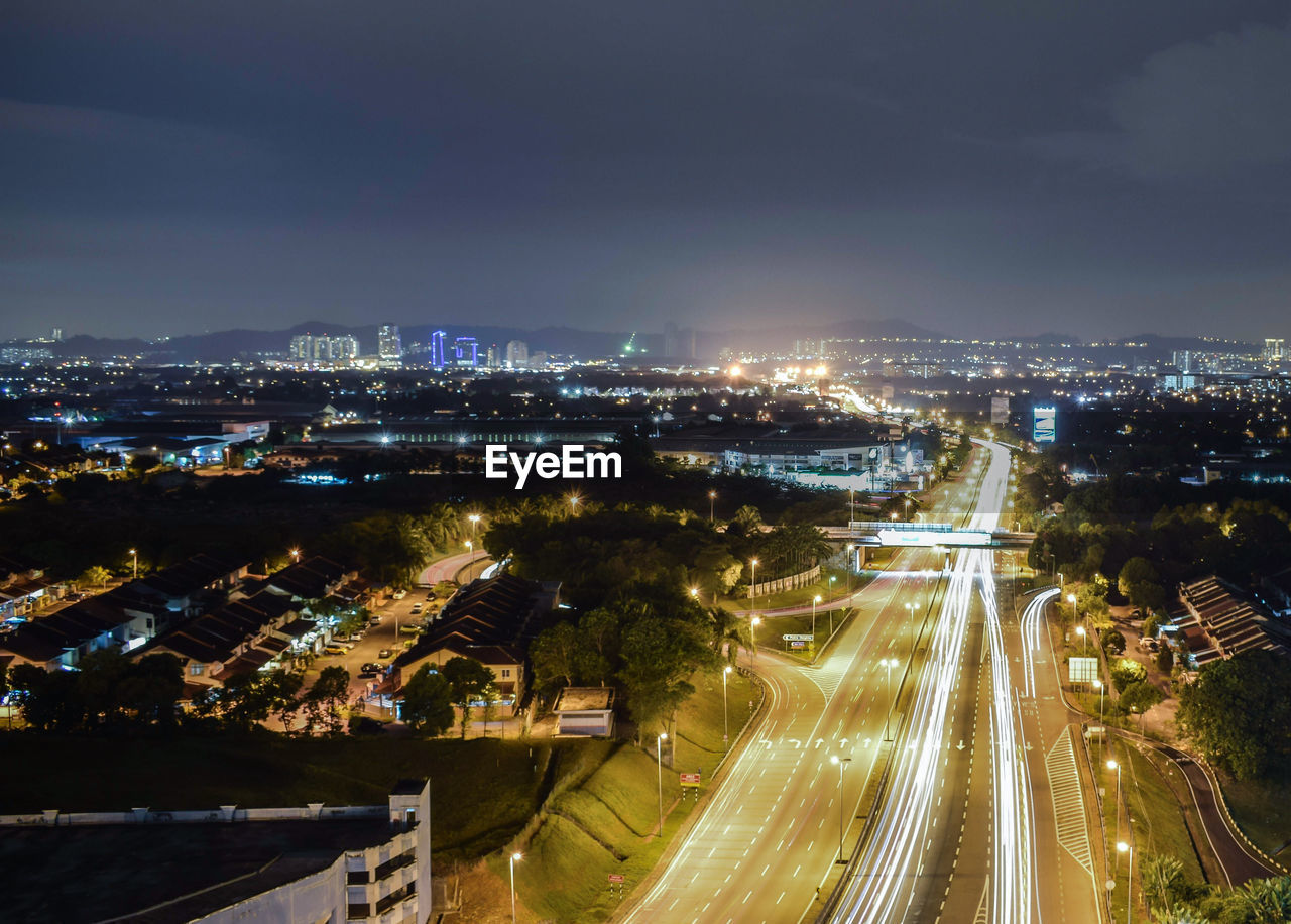 High angle view of illuminated cityscape against sky at night