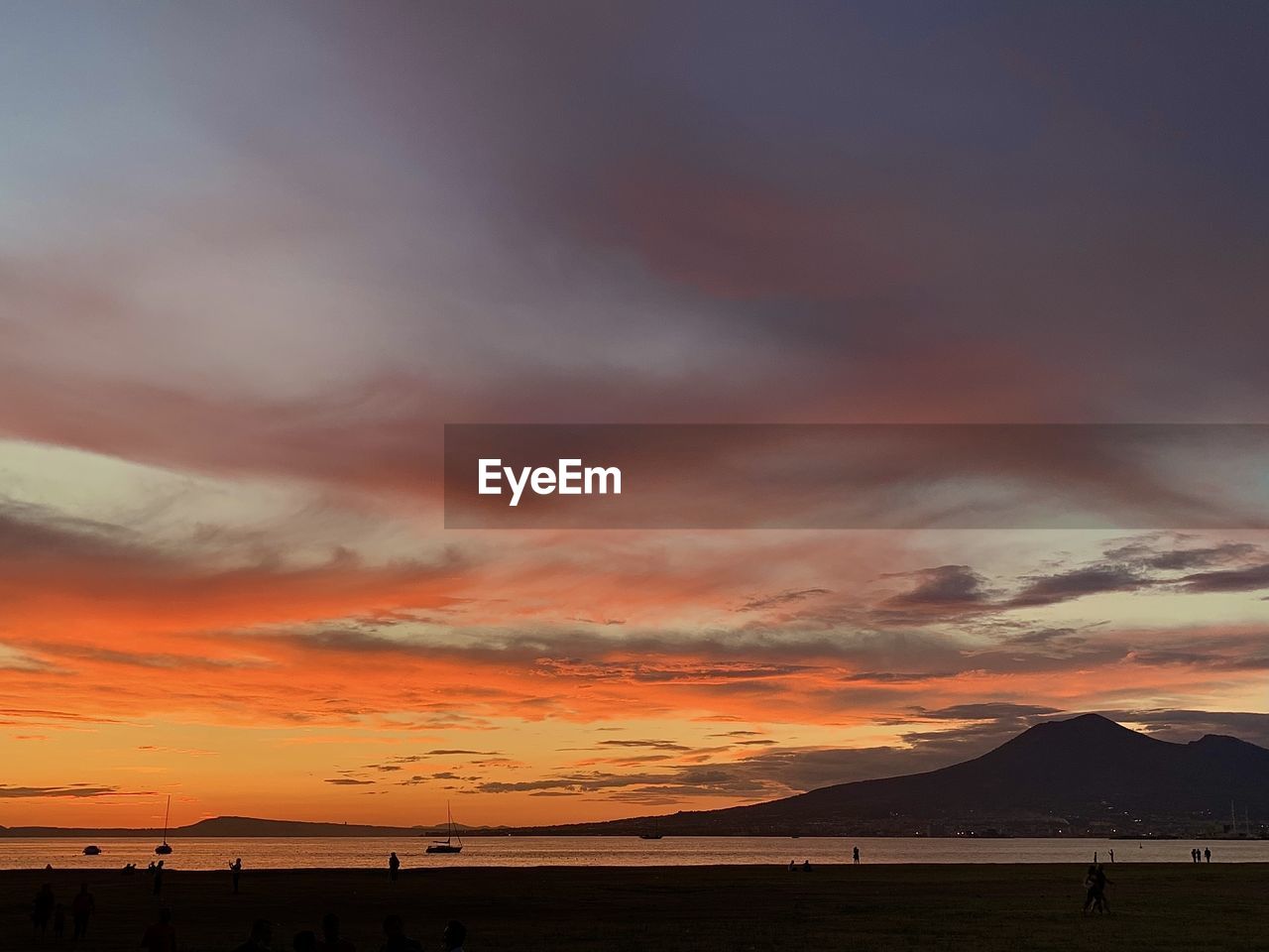 Scenic view of dramatic sky over sea during sunset