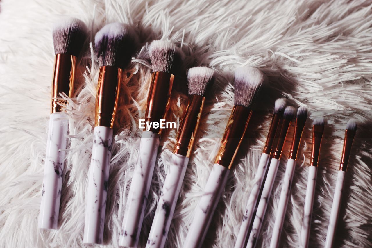 Close-up of make-up brushes on rug