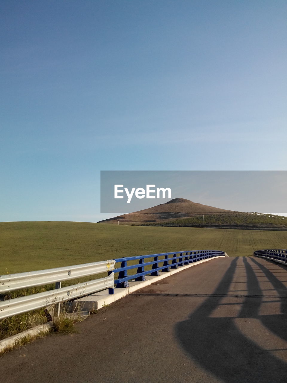 Empty road along countryside landscape