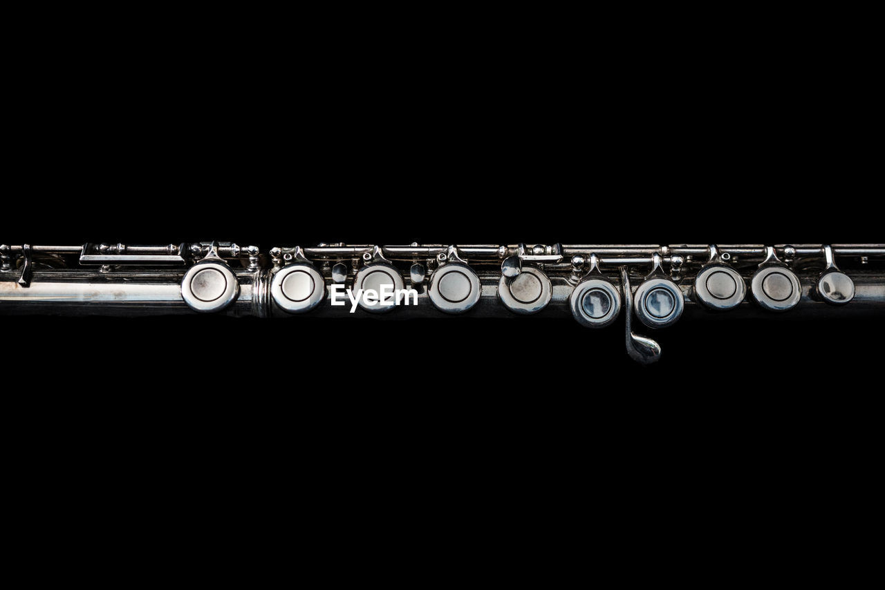 Close-up of flute against black background