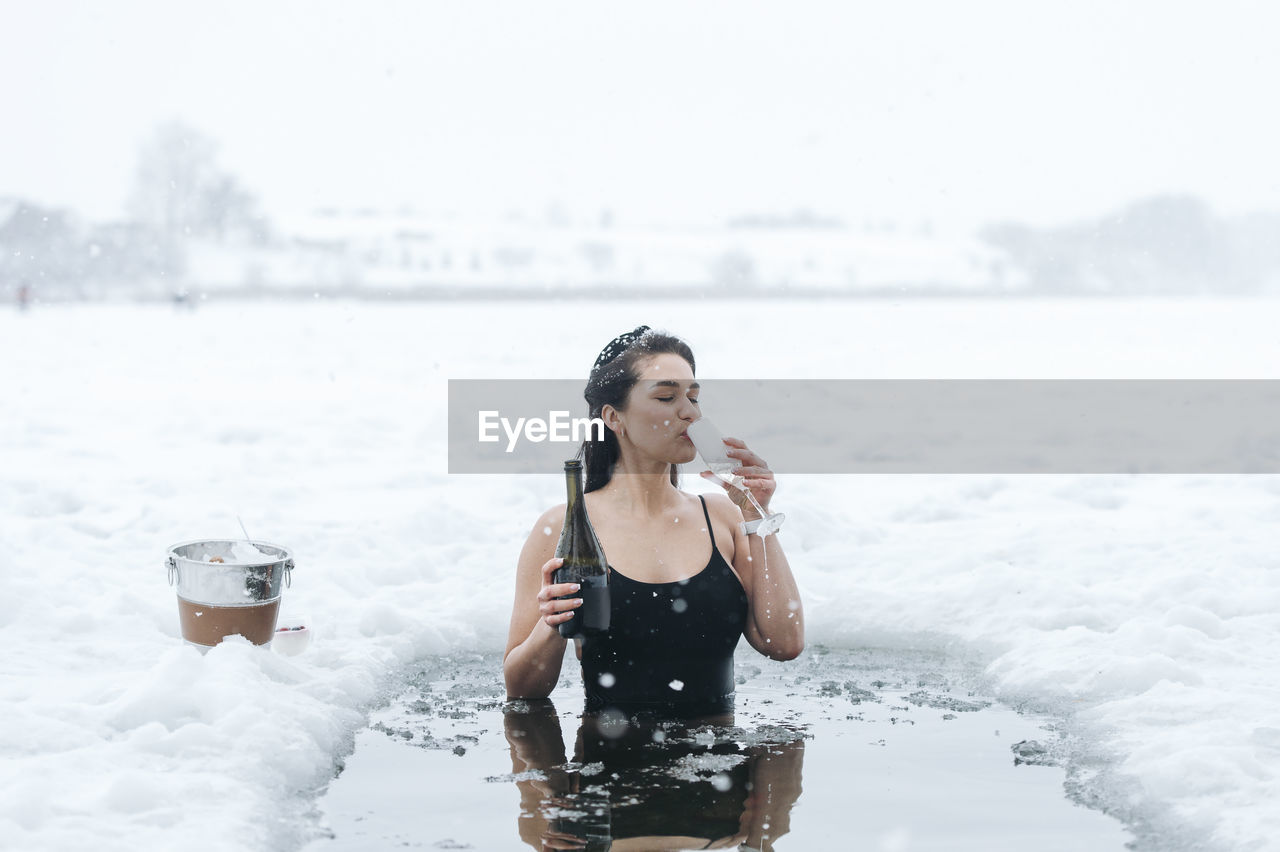 Portrait of young woman swimming in sea